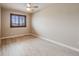 This is a minimal bedroom with a ceiling fan and a window with privacy shutters at 17522 E Dewberry Dr, Parker, CO 80134