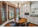 Breakfast nook area with custom cabinets, granite counters and wood-trimmed windows at 17522 E Dewberry Dr, Parker, CO 80134