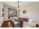 Bright dining room with a modern light fixture and large window overlooking the landscaped yard at 17522 E Dewberry Dr, Parker, CO 80134