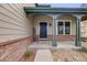 Inviting front porch with brick accents, providing a warm welcome to this lovely home at 17522 E Dewberry Dr, Parker, CO 80134