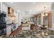Modern kitchen with granite counters and stainless steel appliances, seamlessly connecting to the living spaces at 17522 E Dewberry Dr, Parker, CO 80134
