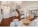 Bright living room with hardwood floors, high ceilings, and staircase with natural light at 17522 E Dewberry Dr, Parker, CO 80134