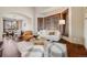 Open-concept living room and dining area with hardwood floors, creating a perfect flow for entertaining at 17522 E Dewberry Dr, Parker, CO 80134