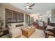 Cozy living room with comfortable seating, hardwood floors, and lots of natural light at 17522 E Dewberry Dr, Parker, CO 80134