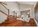 Elegant living area with wood floors, staircase, comfortable seating and bay window with light control at 17522 E Dewberry Dr, Parker, CO 80134