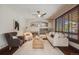 Bright living room featuring hardwood floors, fireplace, and large windows for natural light at 17522 E Dewberry Dr, Parker, CO 80134