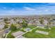 Elevated view of a park with a basketball court, playground, and picnic area surrounded by houses at 17522 E Dewberry Dr, Parker, CO 80134