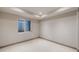 An empty room featuring neutral walls, plush carpet, and a window to let in natural light at 17522 E Dewberry Dr, Parker, CO 80134