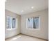 An empty room featuring neutral walls, plush carpet, and two windows to let in natural light at 17522 E Dewberry Dr, Parker, CO 80134