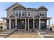 Attractive townhome featuring stone accents, covered porches, and inviting curb appeal in a well-maintained community at 18722 E 99Th Ave, Commerce City, CO 80022