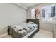Bedroom with a full bed, a unique wall decoration, and a bright window at 1284 Stuart St, Denver, CO 80204