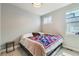 Cozy bedroom with a colorful quilt and a window providing natural light at 1284 Stuart St, Denver, CO 80204