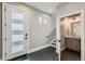 Inviting entryway with geometric tiled floor, modern door, stairs, and adjacent half-bathroom at 1284 Stuart St, Denver, CO 80204