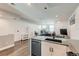 Open-concept kitchen with gray countertops, stainless steel appliances, and views of the living space at 1284 Stuart St, Denver, CO 80204