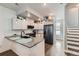 Modern kitchen with white cabinets, gray countertops, stainless appliances, and an island at 1284 Stuart St, Denver, CO 80204