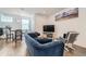 Bright living room with hardwood floors and comfortable furniture including a blue sofa at 1284 Stuart St, Denver, CO 80204