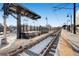 Train tracks view along outdoor platform with shelter, ticketing machines, and lamps at 1284 Stuart St, Denver, CO 80204