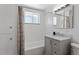 Clean bathroom with white tile, updated vanity, and neutral color scheme at 4728 Dover St, Wheat Ridge, CO 80033