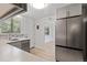Updated kitchen with white countertops, stainless steel appliances and wood floors at 4728 Dover St, Wheat Ridge, CO 80033