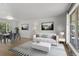 Bright living room featuring hardwood floors, neutral decor, and natural light at 4728 Dover St, Wheat Ridge, CO 80033