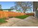Fenced backyard with a combination of grass, a paved patio, and landscaping at 1430 Lashley St, Longmont, CO 80504