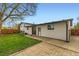Spacious backyard featuring a large grassy area and patio, perfect for outdoor entertaining and relaxation at 1430 Lashley St, Longmont, CO 80504