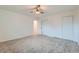 Bedroom with neutral carpet, ceiling fan, and closet system at 1430 Lashley St, Longmont, CO 80504