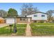 Charming two-story home featuring a well-maintained lawn, brick accents, and inviting curb appeal at 1430 Lashley St, Longmont, CO 80504