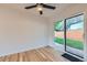 Living room with light hardwood floors and glass sliding door access to the backyard at 1430 Lashley St, Longmont, CO 80504