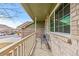 Cozy front porch with bench seating and a large window at 3811 E 138Th Pl, Thornton, CO 80602