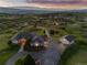 Stunning aerial view of a house with a large driveway and lush landscaping on a sprawling lot with mountain views at 3485 Park Ridge Rd, Sedalia, CO 80135