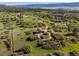 Aerial view of a charming red barn surrounded by greenery, highlighting its rural and peaceful setting at 3485 Park Ridge Rd, Sedalia, CO 80135