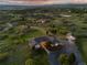 Expansive aerial shot of a home with a circular driveway and a detached garage surrounded by green landscape at 3485 Park Ridge Rd, Sedalia, CO 80135