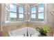 Bright bathroom featuring a soaking tub with shutters overlooking scenic views at 3485 Park Ridge Rd, Sedalia, CO 80135