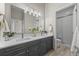 Elegant bathroom with double vanity, large mirror, and glass-enclosed shower at 3485 Park Ridge Rd, Sedalia, CO 80135