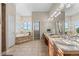 Luxurious bathroom with a soaking tub, dual vanity, and large windows with plantation shutters at 3485 Park Ridge Rd, Sedalia, CO 80135