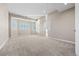 Bright and airy bedroom featuring neutral walls, plush carpeting, and large windows with shutter blinds at 3485 Park Ridge Rd, Sedalia, CO 80135