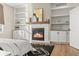 Inviting bedroom featuring a fireplace, custom built-ins, and hardwood floors at 3485 Park Ridge Rd, Sedalia, CO 80135