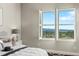 Comfortable bedroom featuring plantation shutters and views of the surrounding scenery at 3485 Park Ridge Rd, Sedalia, CO 80135