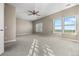 Bright, neutral bedroom with large windows overlooking mountains and a ceiling fan at 3485 Park Ridge Rd, Sedalia, CO 80135