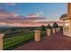 Expansive deck offering breathtaking panoramic views of the surrounding landscape at sunset at 3485 Park Ridge Rd, Sedalia, CO 80135