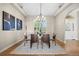 Elegant dining room with a modern chandelier, stylish artwork, and seating for six guests at 3485 Park Ridge Rd, Sedalia, CO 80135