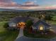 Beautifully landscaped front yard of a two-story home with stone accents and an inviting entryway at dusk at 3485 Park Ridge Rd, Sedalia, CO 80135