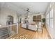 Open-concept living room featuring hardwood floors, modern furnishings, fireplace, and abundant natural light at 3485 Park Ridge Rd, Sedalia, CO 80135