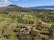 Aerial view highlighting the property outline, showcasing the main house, barn, and expansive green landscape at 3485 Park Ridge Rd, Sedalia, CO 80135