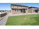 Spacious backyard features a pristine lawn, gravel accents, and a modern home design at 1860 Chaffee Crest Dr, Berthoud, CO 80513