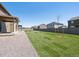 Well-manicured backyard with lush green grass and a charming gravel path; perfect for outdoor enjoyment at 1860 Chaffee Crest Dr, Berthoud, CO 80513