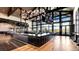 Upscale bar with elegant lighting, a spacious countertop, and floor-to-ceiling windows overlooking a scenic landscape at 1860 Chaffee Crest Dr, Berthoud, CO 80513