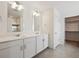 Elegant bathroom featuring double vanity sinks, white cabinets, and modern fixtures at 1860 Chaffee Crest Dr, Berthoud, CO 80513