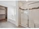 Modern bathroom featuring a shower with glass door and separate soaking tub next to walk-in closet at 1860 Chaffee Crest Dr, Berthoud, CO 80513
